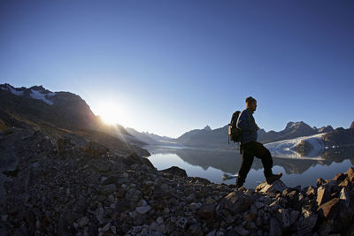 Man hiking at a fjord in eastern greenland