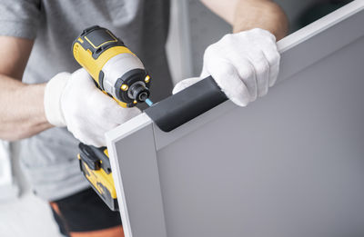 Cropped hand of man repairing car