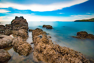 Rocks on beach against sky