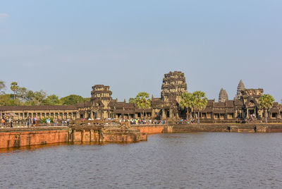 View of temple by building against sky