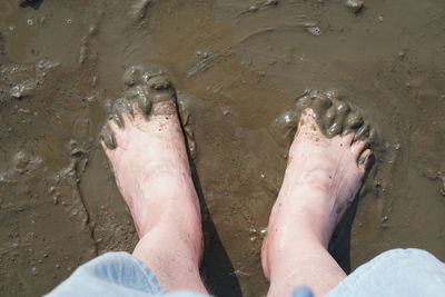 Low section of man legs in water