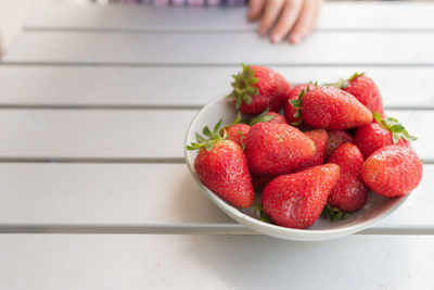 High angle view of strawberries in bowl on table