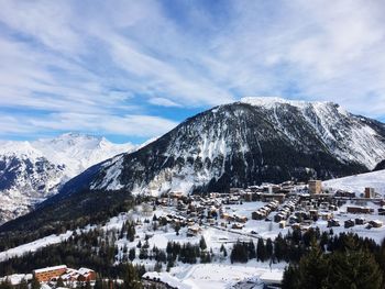 Scenic view of snowcapped mountains against sky