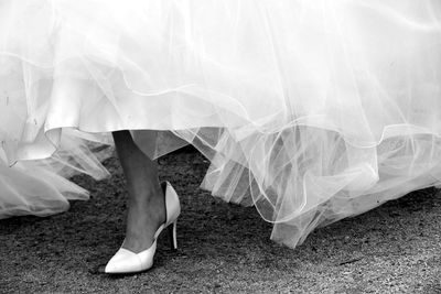 Low section of bride wearing high heels