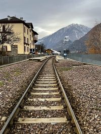 Railroad tracks against sky during sunset