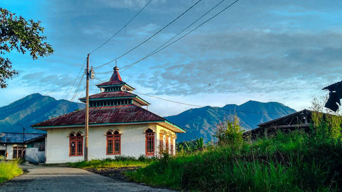 Traditional building on mountain against sky