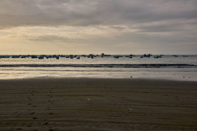 Scenic view of beach against sky during sunset