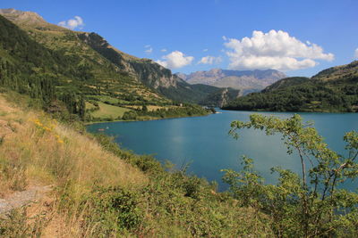 Scenic view of lake and mountains against sky