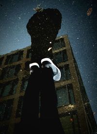 High angle view of man standing on puddle with reflection