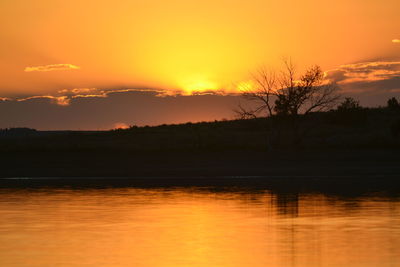 Scenic view of lake against romantic sky at sunset