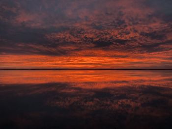 Scenic view of sea against romantic sky at sunset