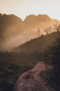 Scenic view of land against sky during sunset