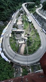 High angle view of road amidst trees in city