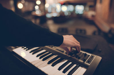 Close-up of hands playing the piano