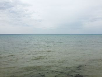 Scenic view of sea against cloudy sky