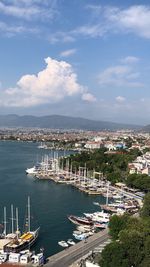 High angle view of harbor by city against sky