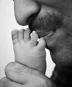 Father kissing leg of newborn baby. fatherhood moments, father's day. 