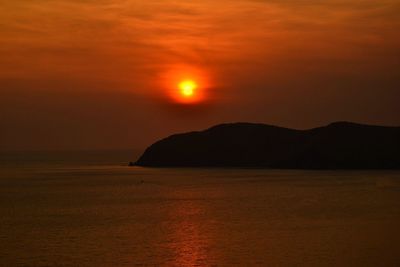 Scenic view of sea against orange sky