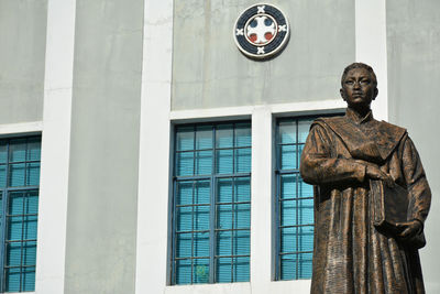 Low angle view of statue against building