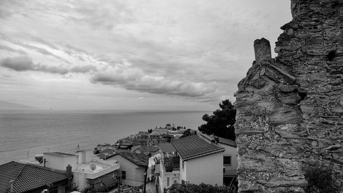 High angle view of buildings by sea against sky