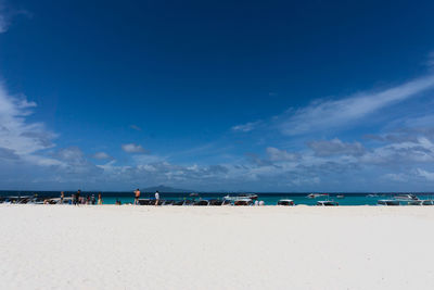 Scenic view of beach against blue sky