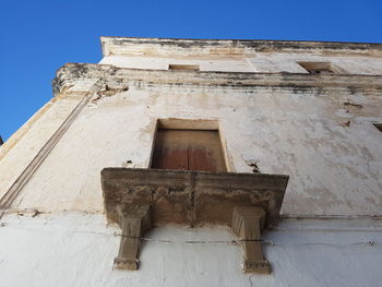 Low angle view of built structure against clear blue sky