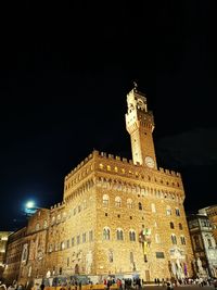 Low angle view of illuminated building against sky at night