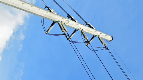 Low angle view of telephone pole against sky