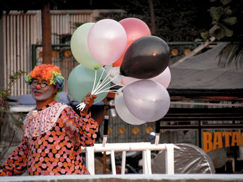 Clown selling balloons outdoors