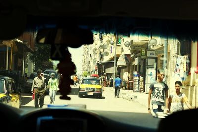 Men on car in city