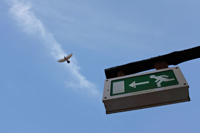 Low angle view of signboard against sky