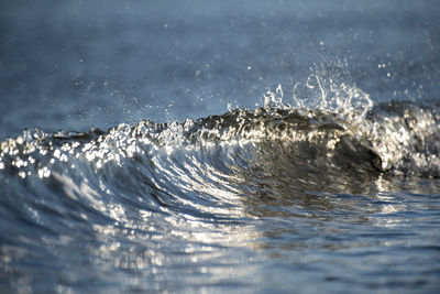 Water splashing in sea against sky