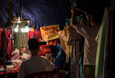 Rear view of people at market stall