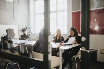 Male and female entrepreneurs planning strategy sitting in board room at office