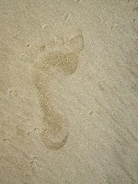 High angle view of footprints on sand