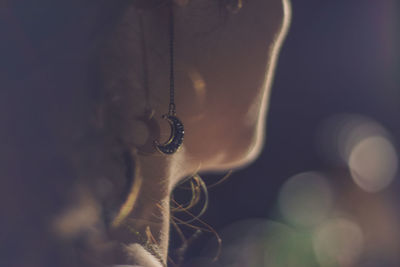 Close-up of woman hanging on metal chain