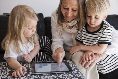 Grandmother with granddaughter using laptop