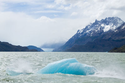 Scenic view of sea and mountains against sky