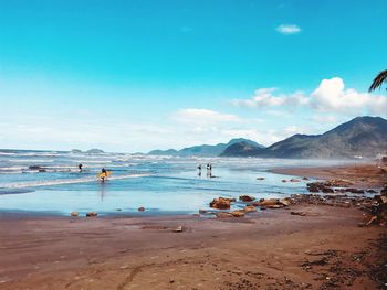 Scenic view of beach against blue sky