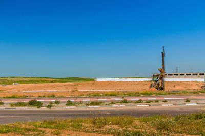 Scenic view of field against clear blue sky