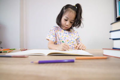 Portrait of girl studying at table