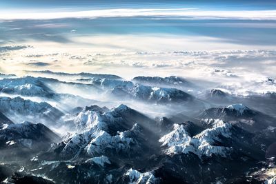 Aerial view of snowcapped mountains against sky