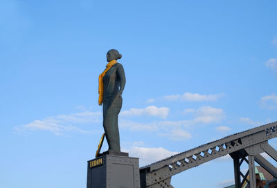 Low angle view of statue against blue sky