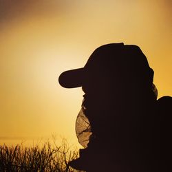 Silhouette woman against clear sky during sunset