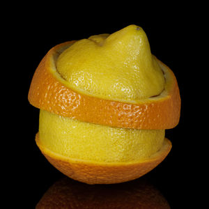 Close-up of orange slice against black background