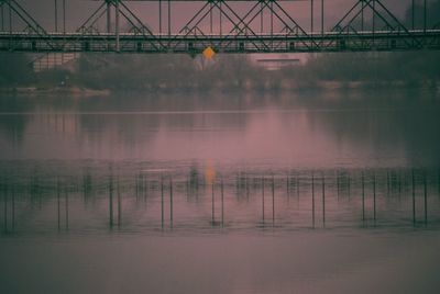 View of bridge over river in foggy weather