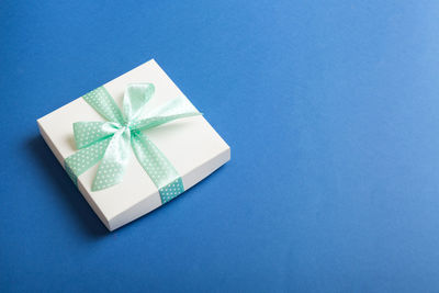 Directly above shot of gift box on blue background