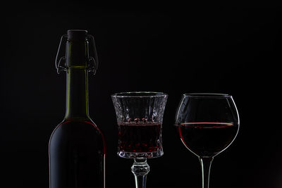 Close-up of wine glass against black background