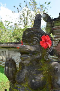Close-up of statue against red wall