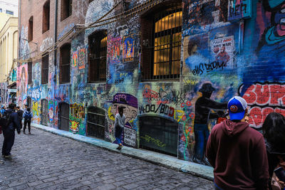 Rear view of people walking on street